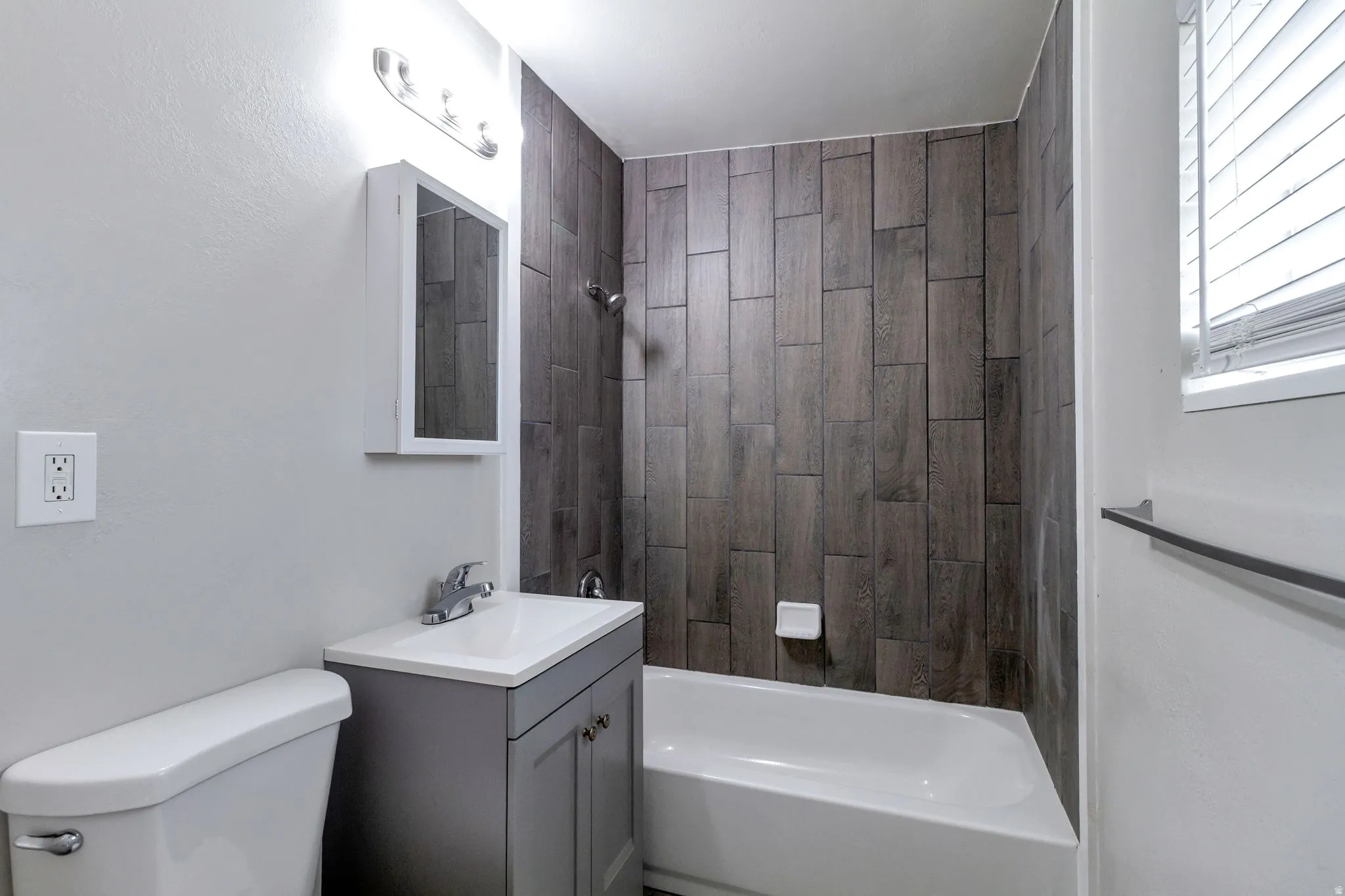 Full bathroom featuring vanity and tub / shower combination