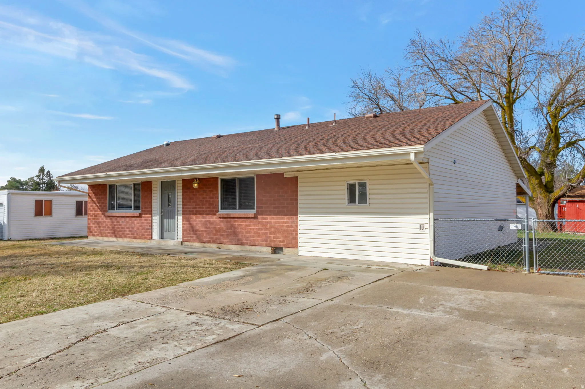 View of front of home featuring brick siding and a shingled roof