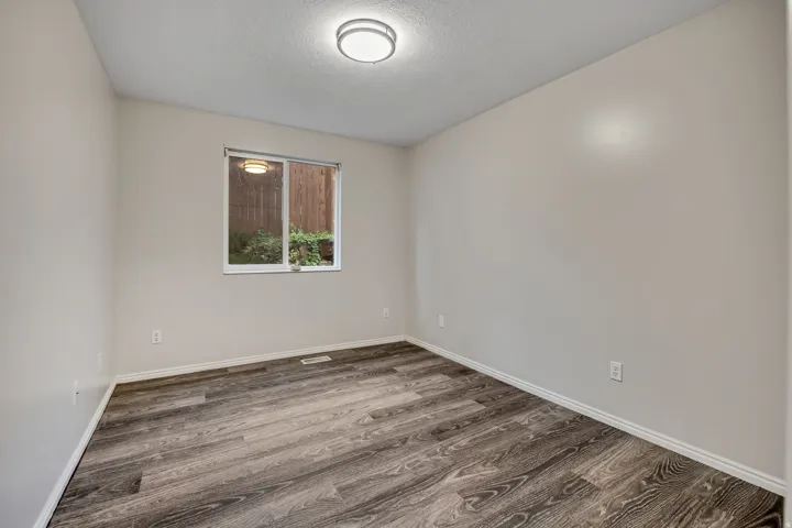 Spare room featuring dark wood-style floors and a textured ceiling