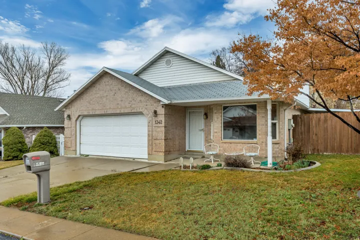 Ranch-style home featuring roof with shingles, an attached garage, a porch, concrete driveway, and brick siding