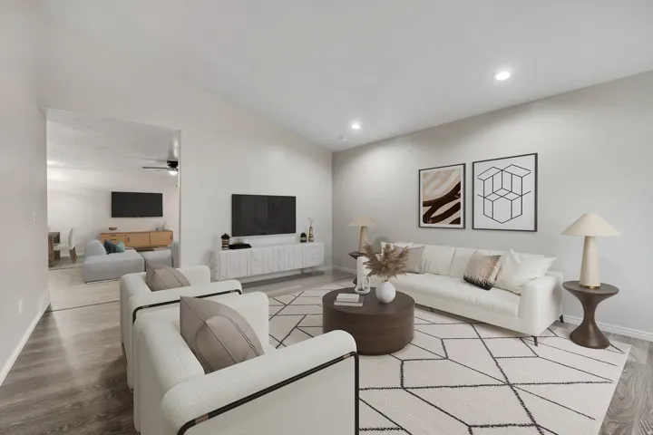 Living area featuring wood finished floors, lofted ceiling, recessed lighting, and a ceiling fan