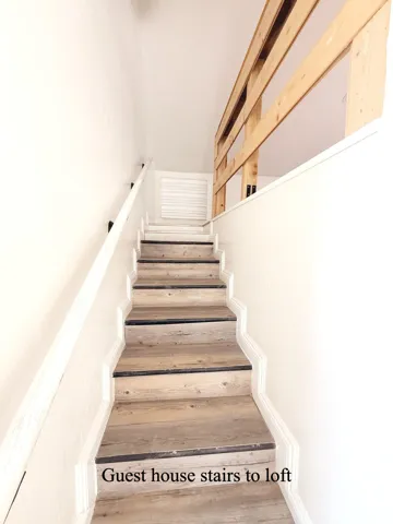 Staircase featuring hardwood / wood-style floors
