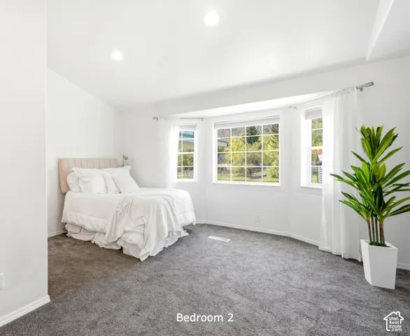 Guest bedroom with en-suite bathroom and bay windows. Facing S.