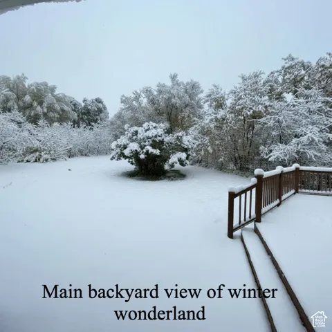 Snowy yard featuring a deck