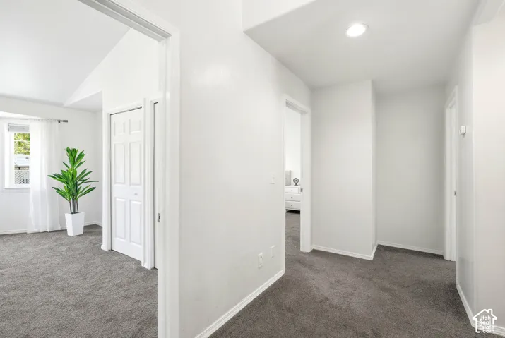 Hallway featuring recessed lighting, light gray carpet, and white trim