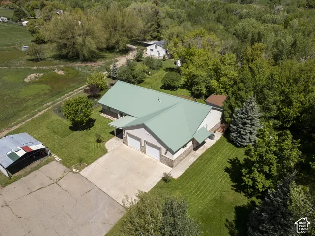 Ranch-style residence featuring a metal roof, attached two-car garage, and a concrete driveway
