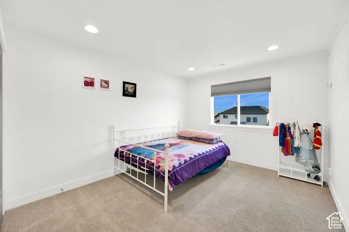 Bedroom featuring light colored carpet and recessed lighting