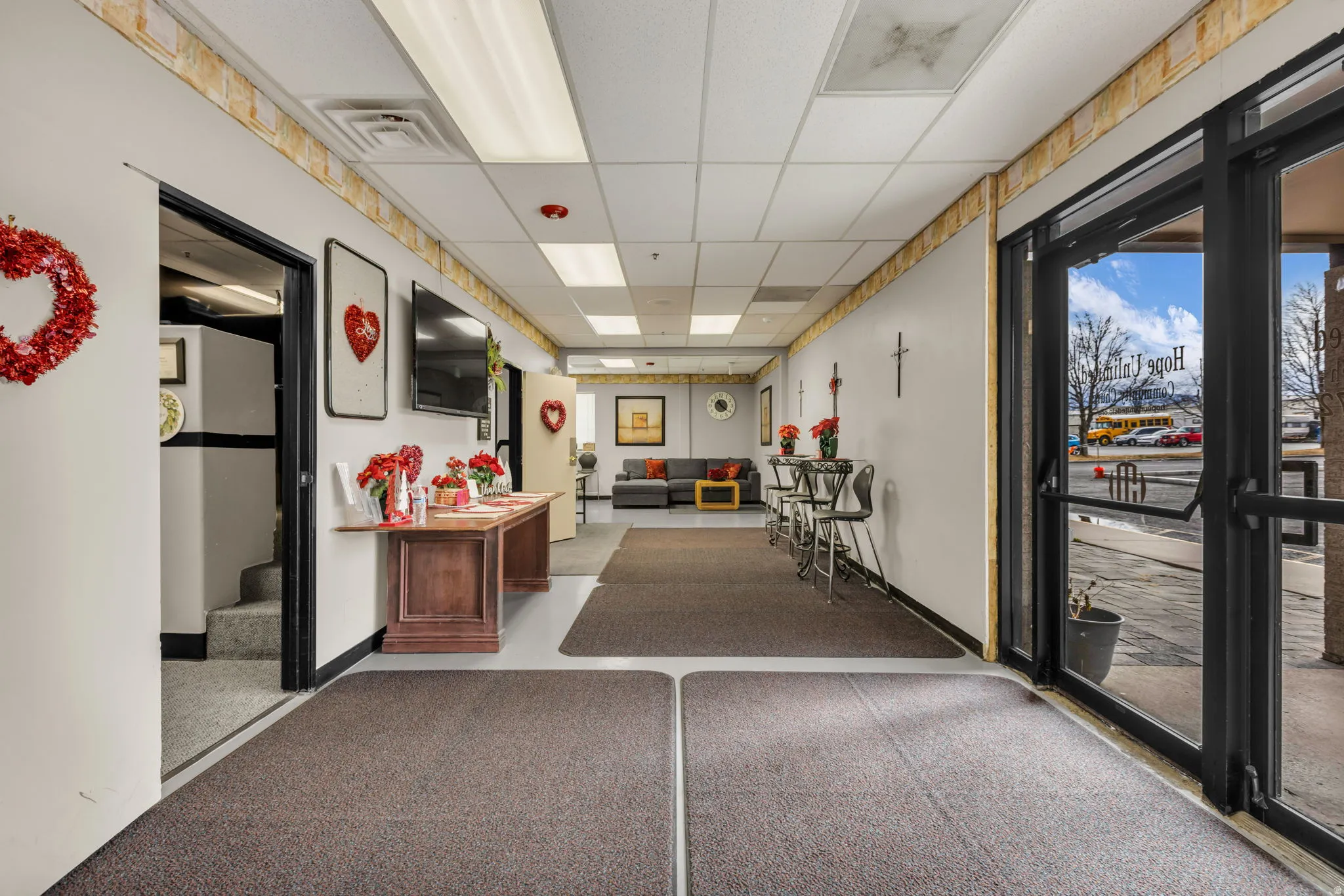 Lobby with a drop ceiling and stairs