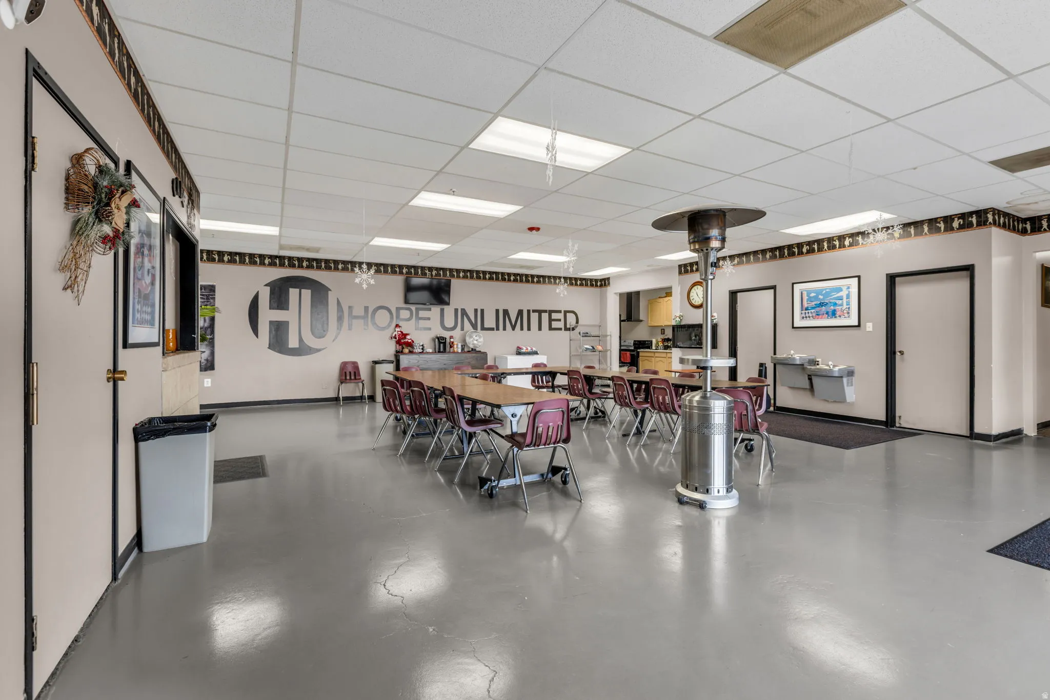 Dining room with finished concrete flooring and a drop ceiling