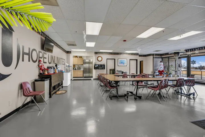 Dining space featuring finished concrete floors and a drop ceiling