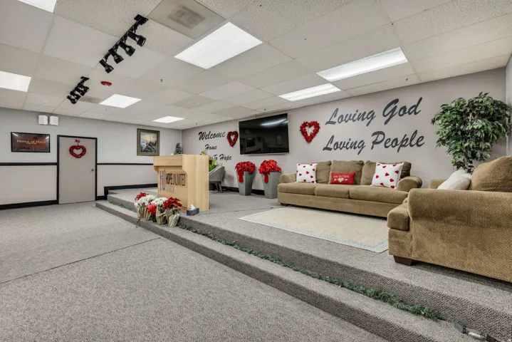 Living room with a paneled ceiling and carpet floors
