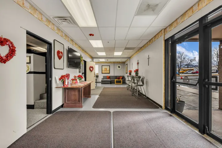 Lobby with a drop ceiling and stairs