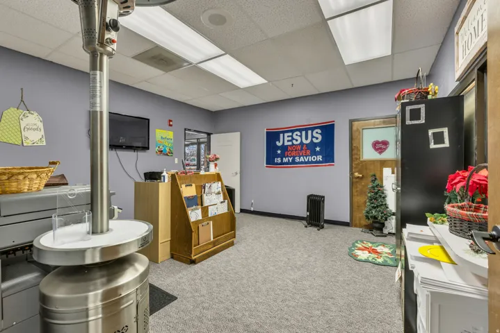 Game room featuring a paneled ceiling and radiator heating unit