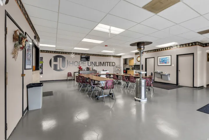 Dining room with finished concrete flooring and a drop ceiling