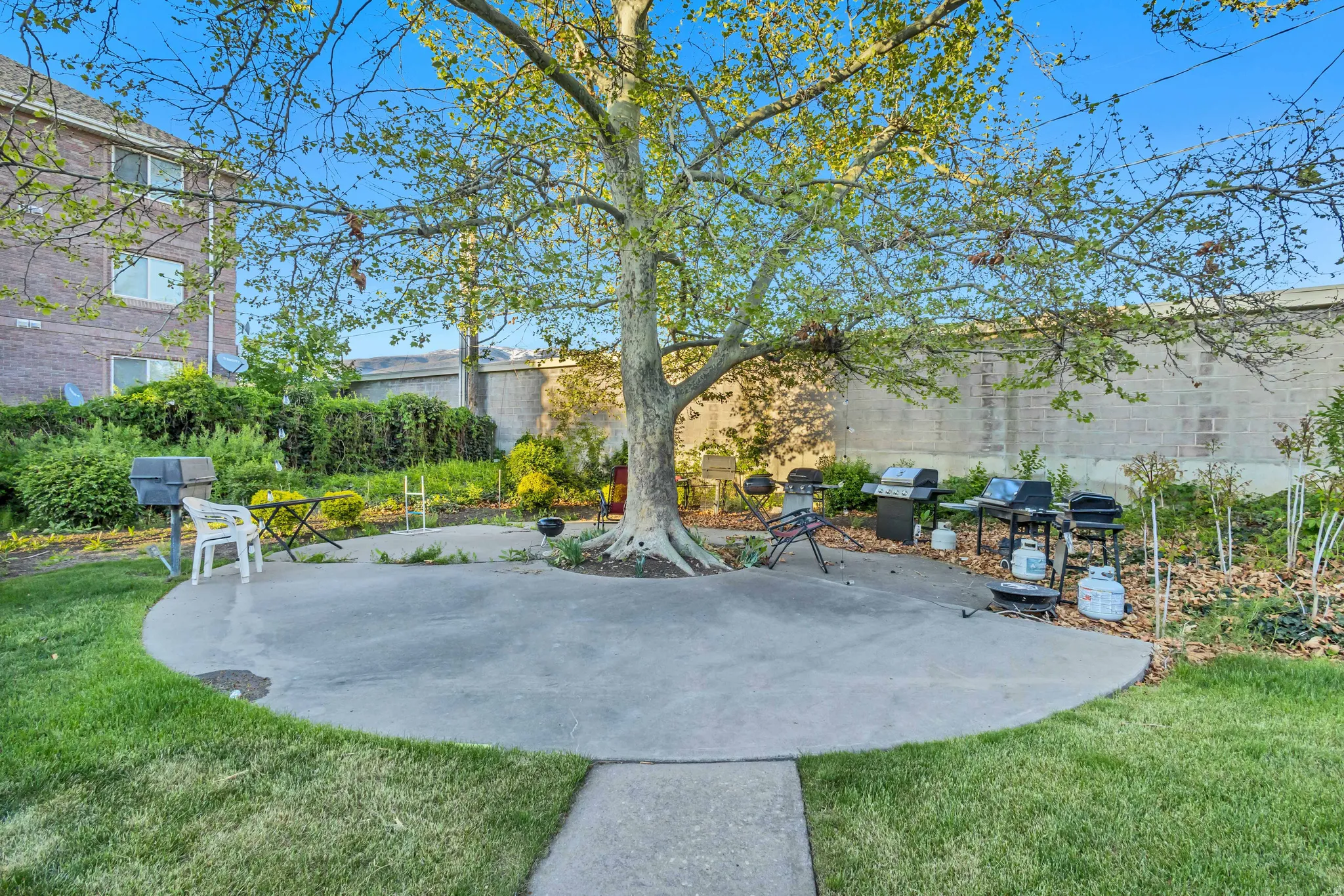 Fenced backyard with a patio area and grilling area