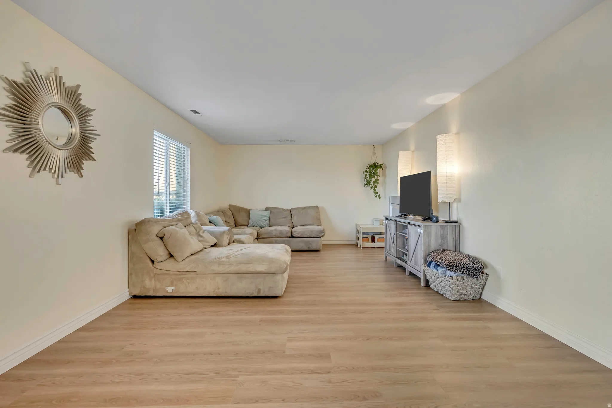 Living area with light wood finished floors and baseboards