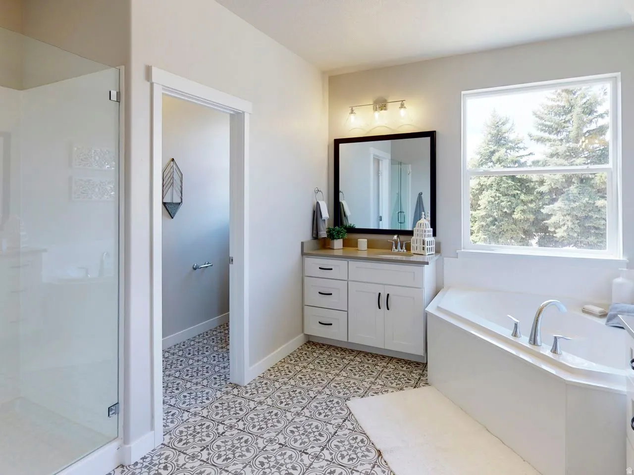 Full bath with vanity, a bath, and a stall shower