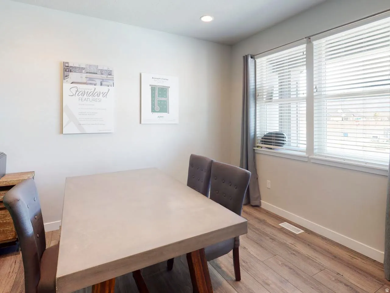 Dining area with light wood-style floors and recessed lighting