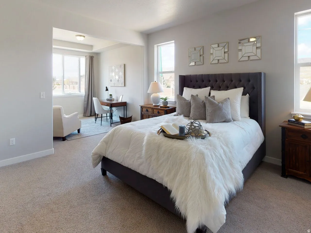 Bedroom with multiple windows and light colored carpet