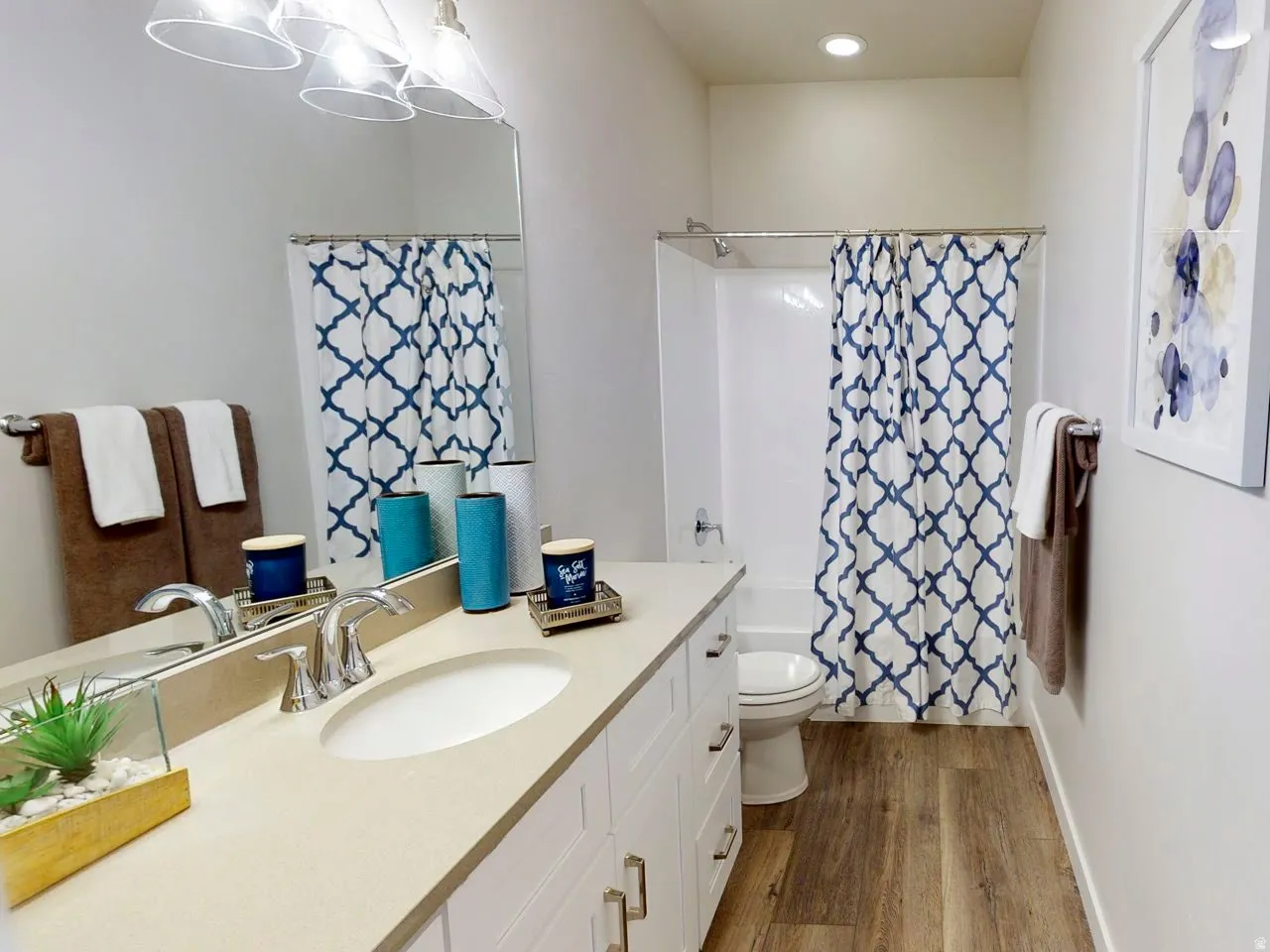 Bathroom featuring vanity, shower / bath combo, dark wood-type flooring, and recessed lighting