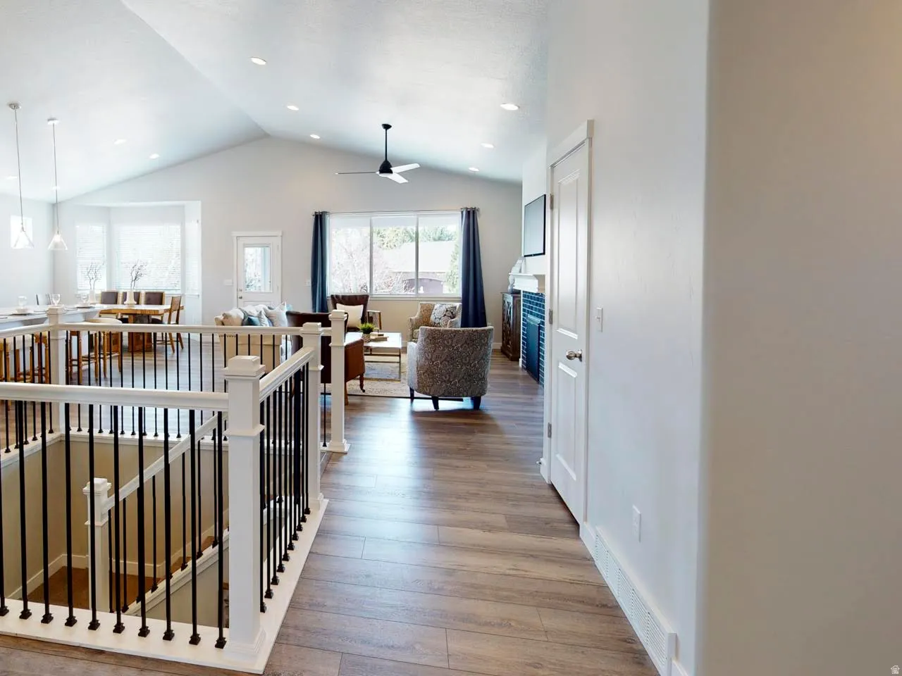 Hall featuring an upstairs landing, light wood-type flooring, and recessed lighting