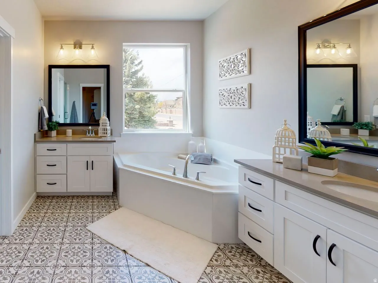 Bathroom with two vanities and a garden tub