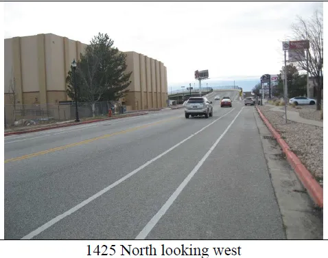 View of asphalt street with curbs and sidewalks