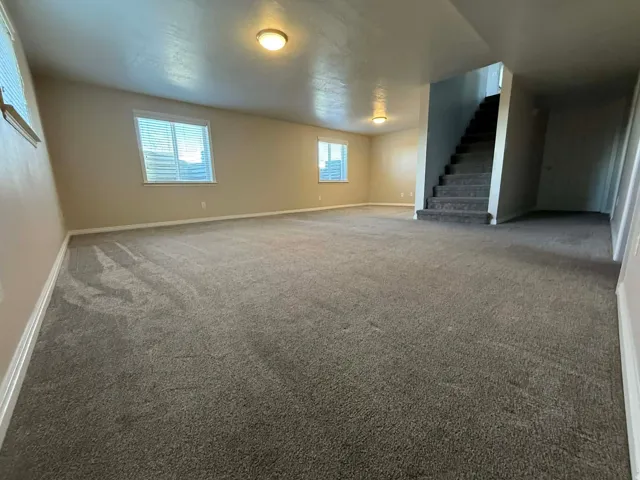 Below grade area with baseboards and carpet