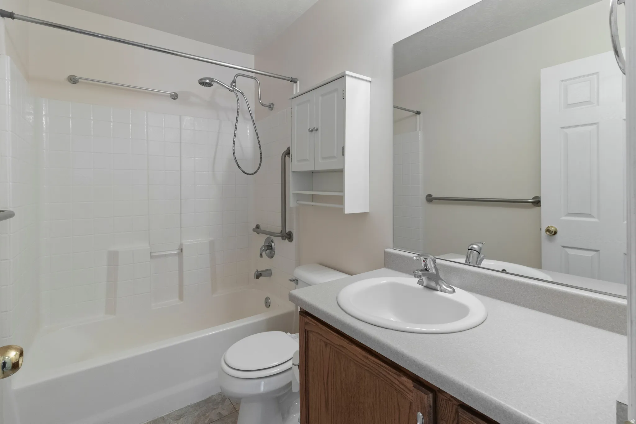 Bathroom featuring vanity and washtub / shower combination