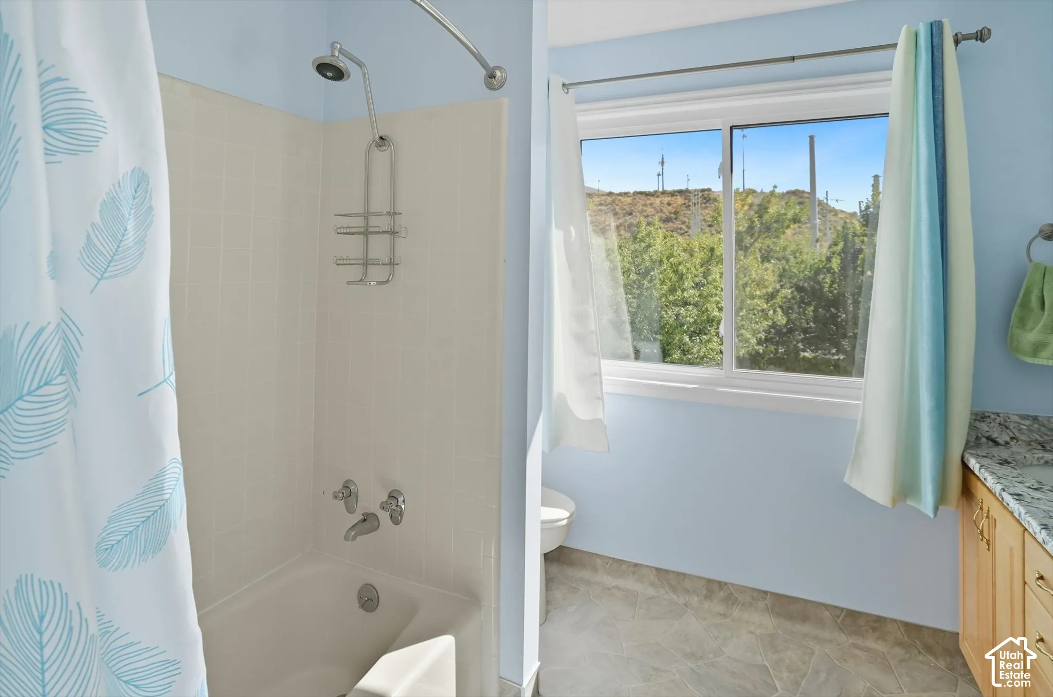 Full bathroom featuring vanity and shower / bath combination with curtain