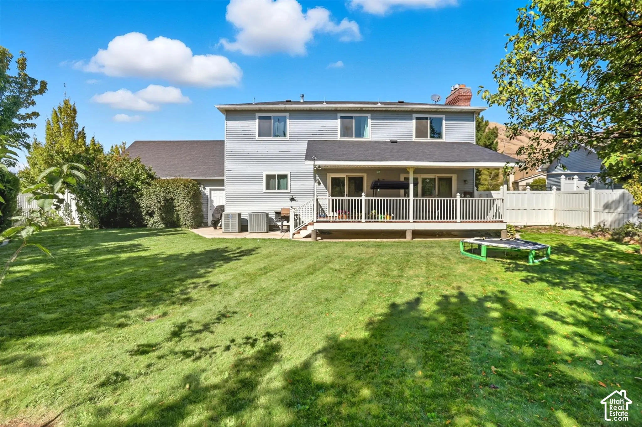 Back of property with a chimney and a deck