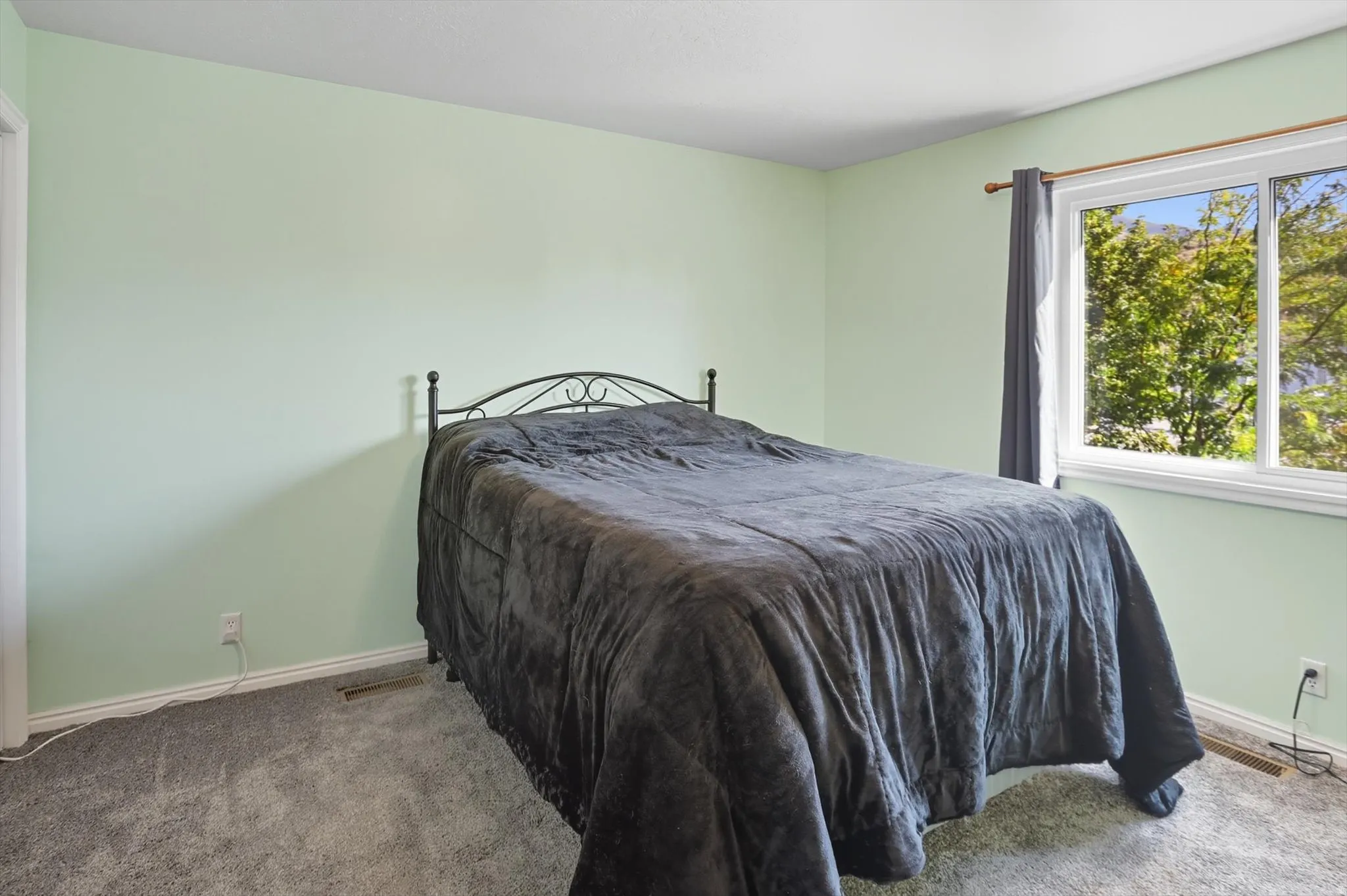 Carpeted bedroom featuring baseboards