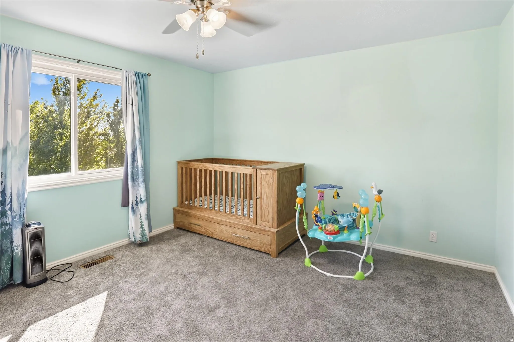Carpeted bedroom with baseboards and ceiling fan