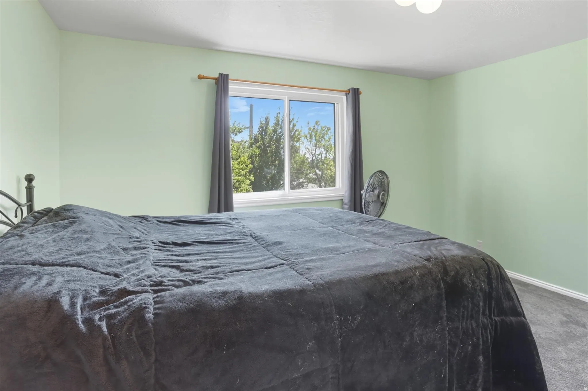 Carpeted bedroom with baseboards