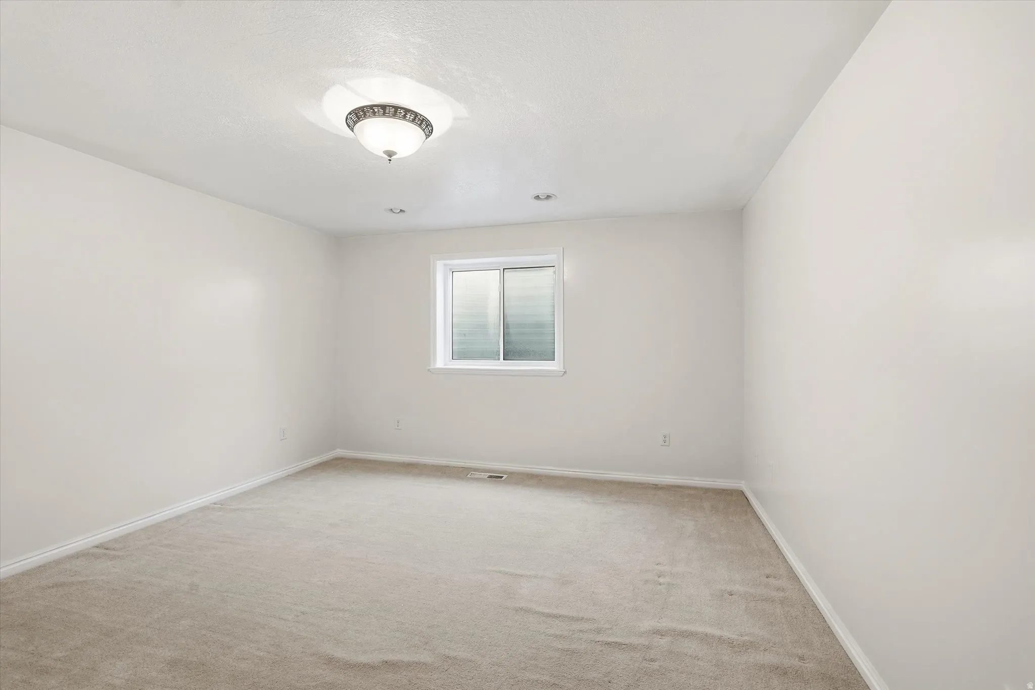 Unfurnished room featuring baseboards and light colored carpet