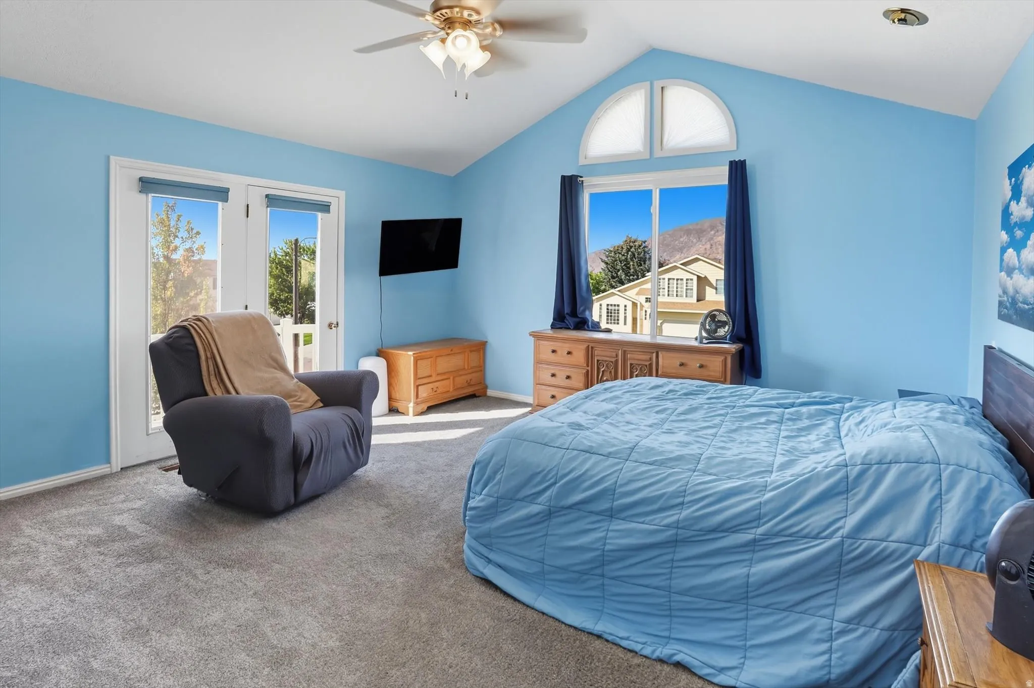 Carpeted bedroom with access to exterior and a ceiling fan