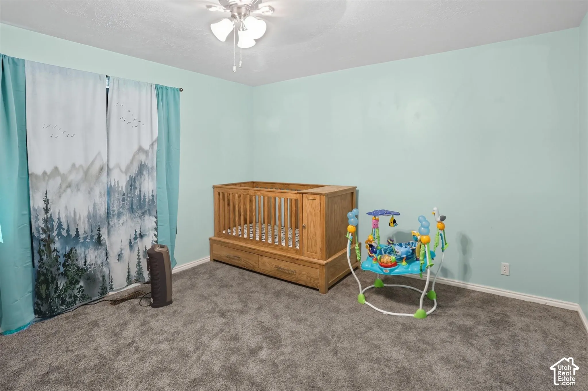 Bedroom with carpet floors, ceiling fan, and a textured ceiling