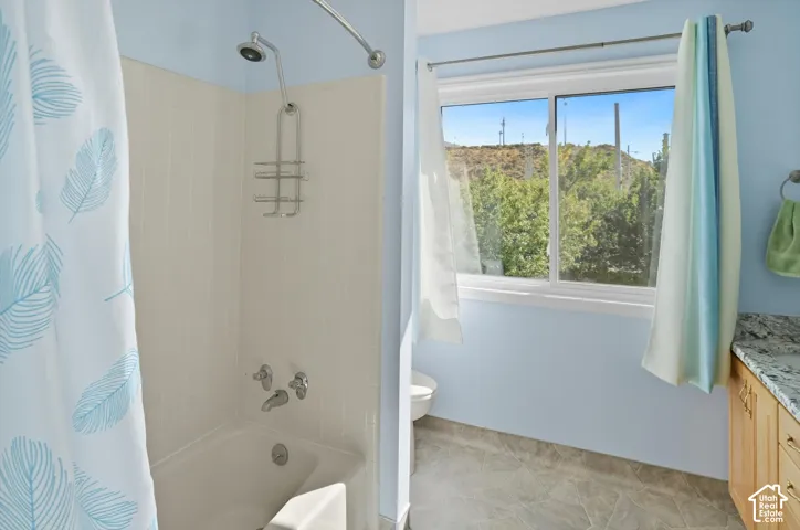 Full bathroom featuring vanity and shower / bath combination with curtain