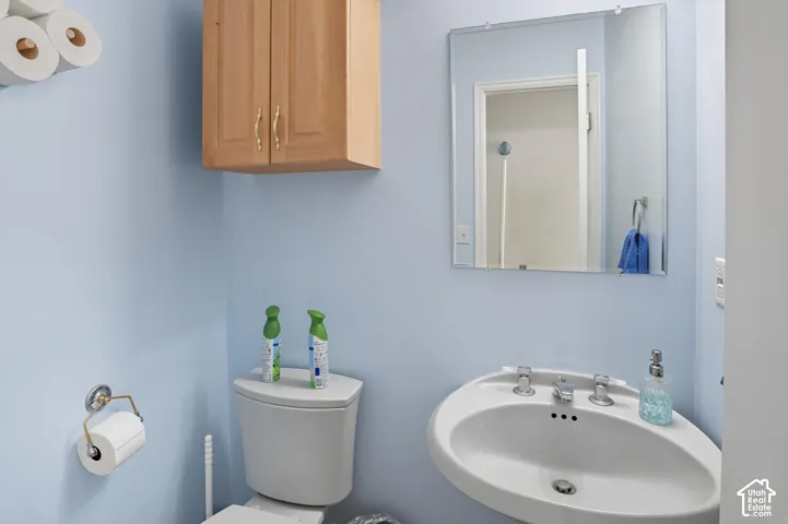 Half bathroom featuring a sink and toilet