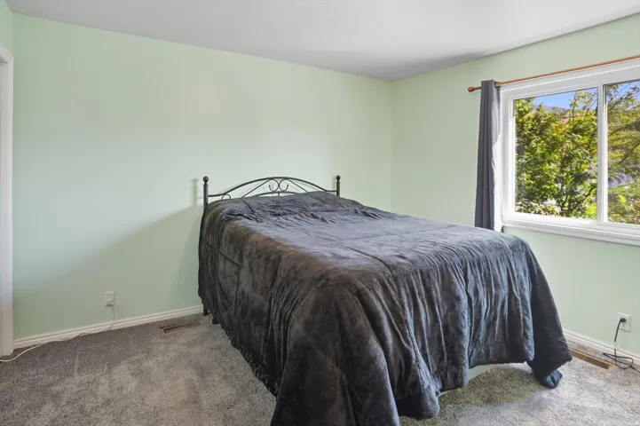 Carpeted bedroom featuring baseboards