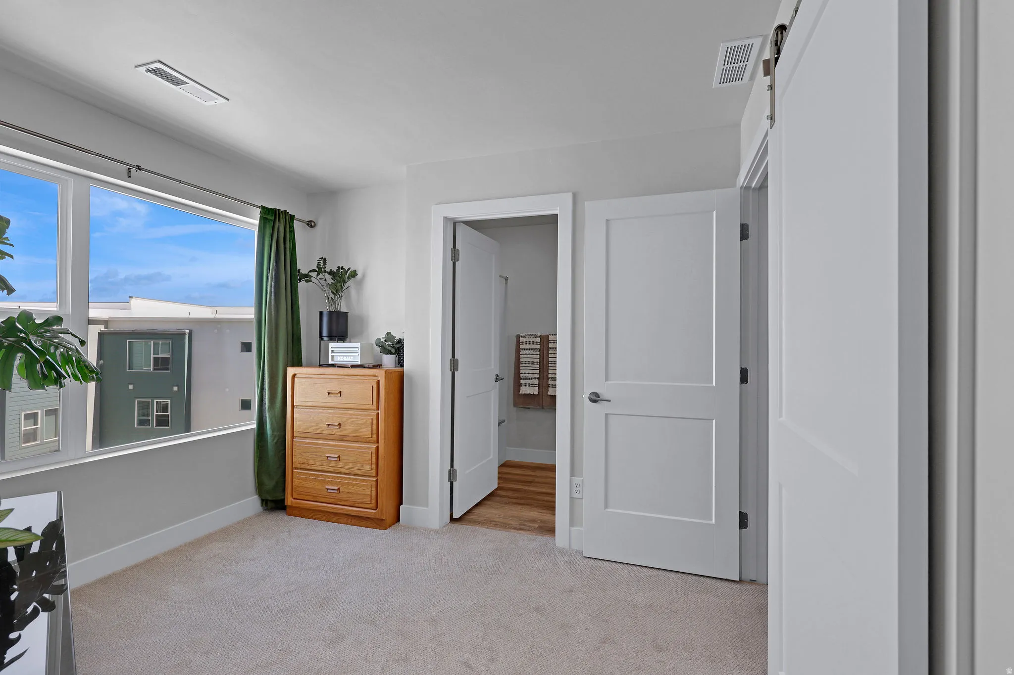 Bedroom with light carpet and baseboards