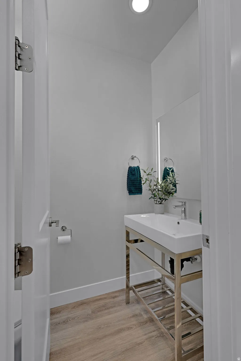 Bathroom with light wood finished floors and baseboards