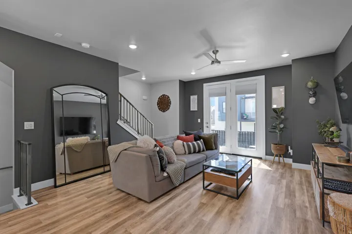 Living room featuring a ceiling fan, light wood-style flooring, and recessed lighting