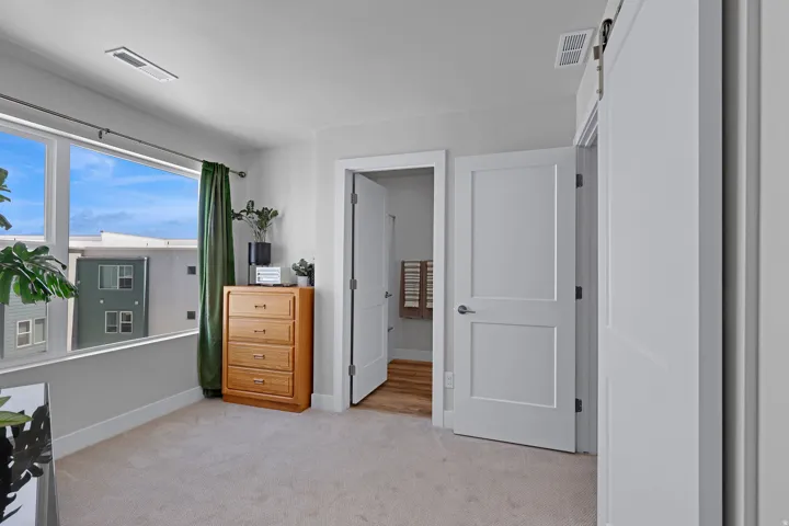 Bedroom with light carpet and baseboards