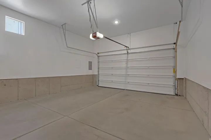 Garage featuring a garage door opener