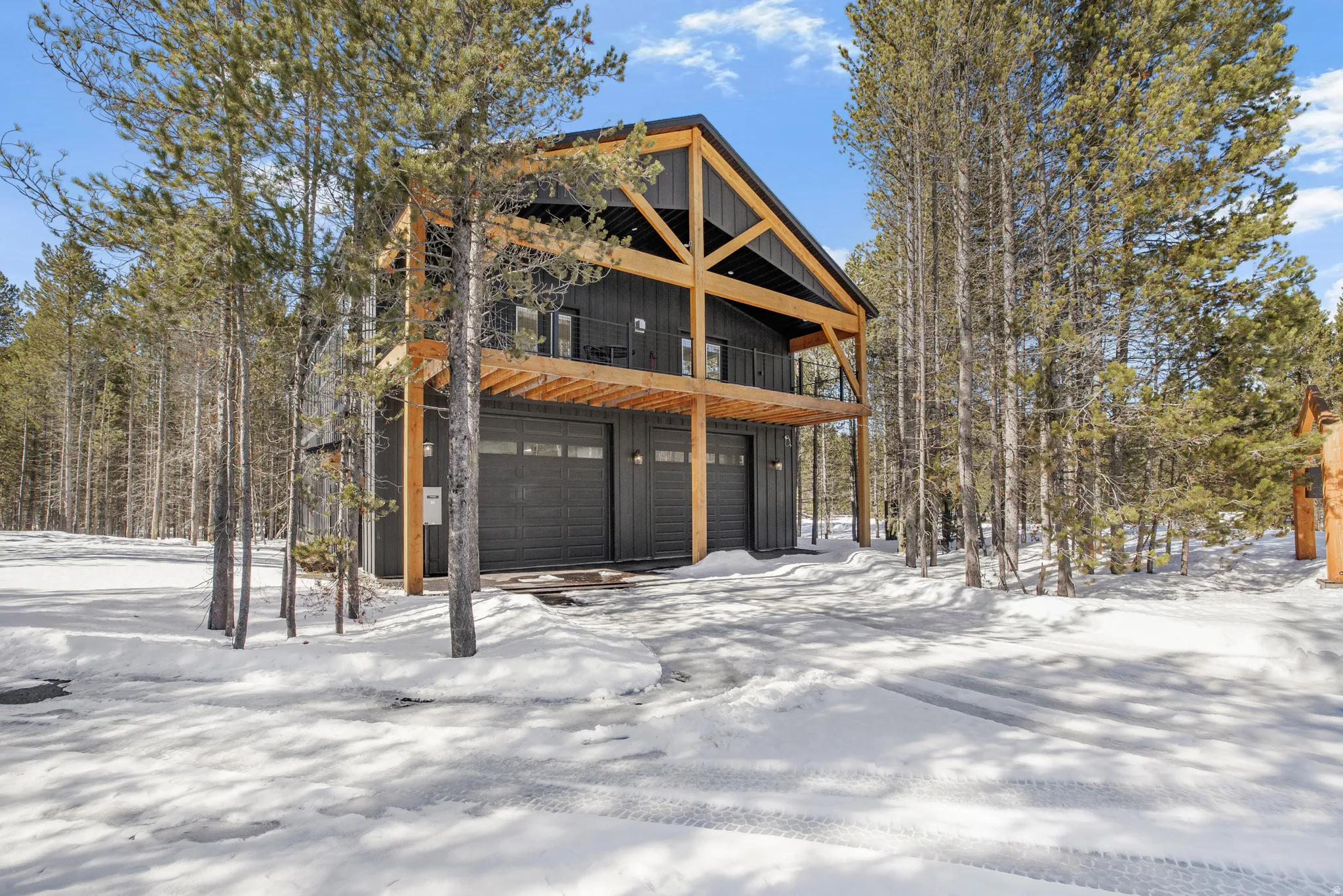 View of front of property featuring a balcony, a garage, and board and batten siding