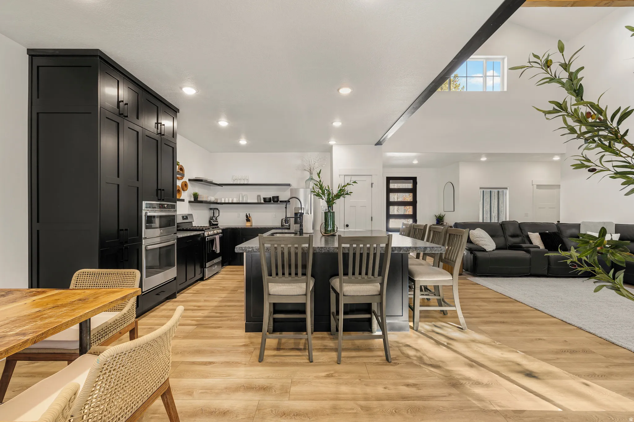 Dining room featuring light wood finished floors, a high ceiling, and recessed lighting