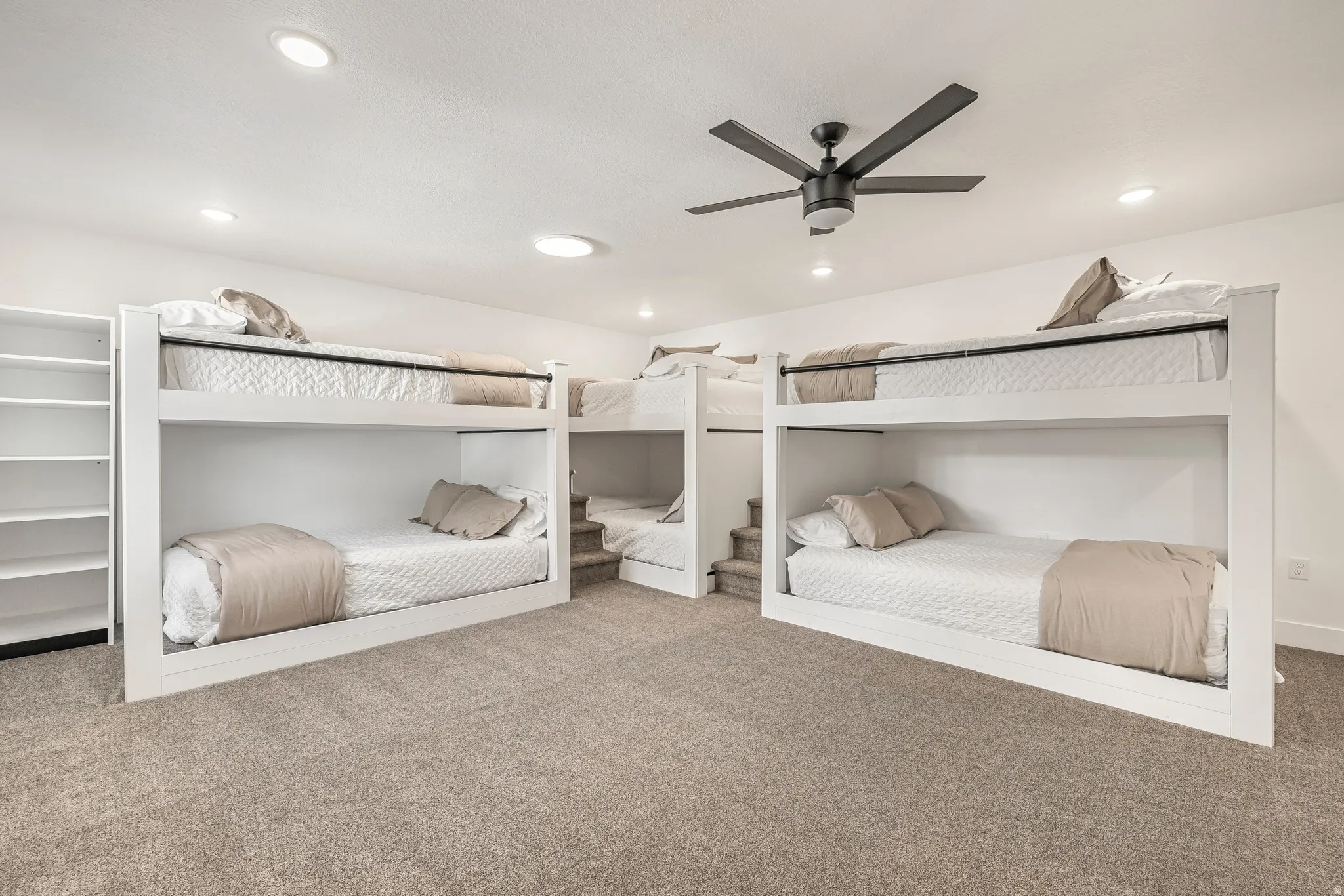 Carpeted bedroom with ceiling fan