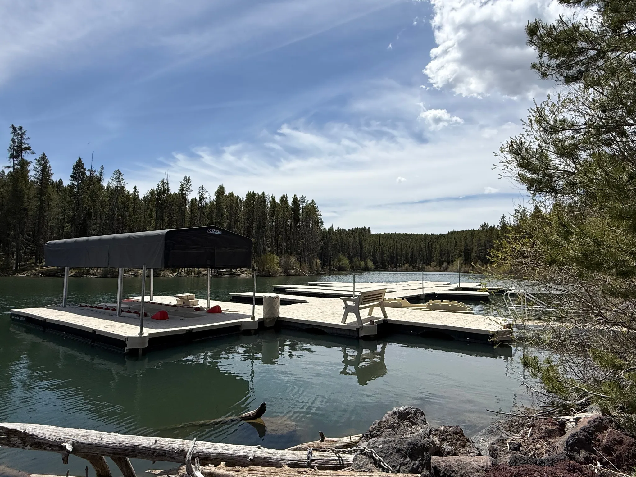 Private dock system featuring multiple platforms and a covered boat slip