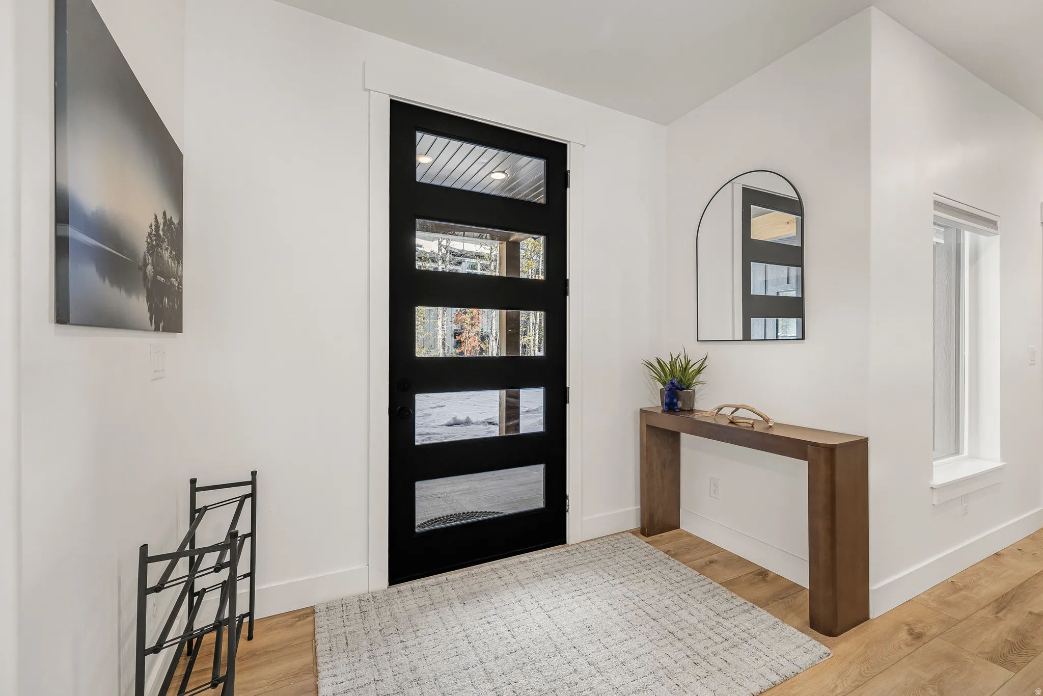 Foyer featuring light wood-type flooring and baseboards